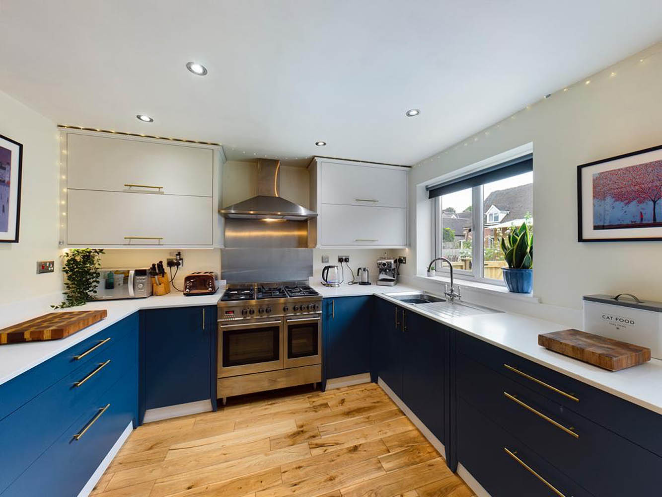 Handmade kitchen with blue painted units and brass handles, Shropshire