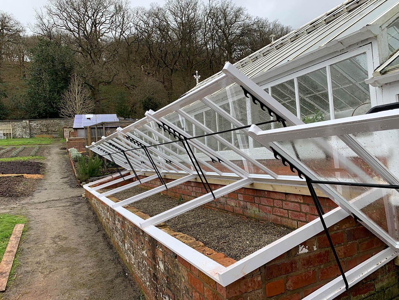 Renovated Victorian cold frame showing new openers and ironwork, Shropshire